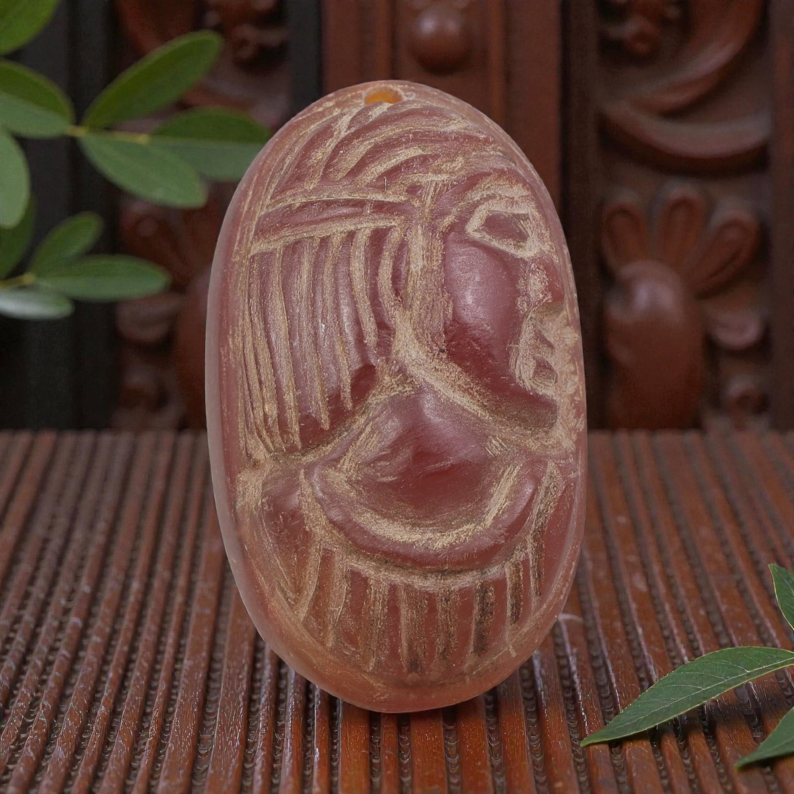 Antique Egyptian Carnelian Intaglio with Profile Head Motif, 94AN: Carved from carnelian with rich reddish-orange coloration, the oval-shaped intaglio features an incised profile head of a figure wearing a detailed headdress. The carving includes defined facial featu
