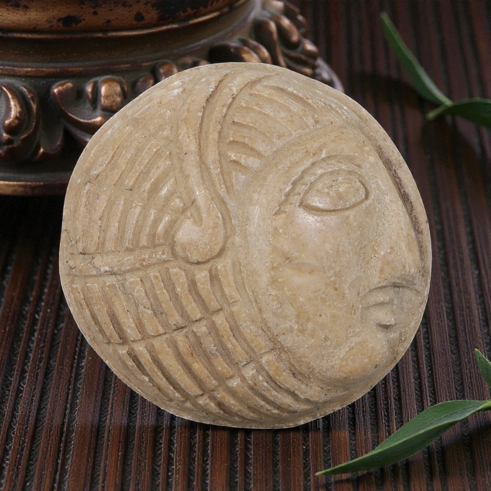 Antique Egyptian Steatite Intaglio with Profile Head Motif, 36YD: This ancient intaglio is carved from weathered light tan steatite, with a smooth circular form. The face features a deeply engraved relief depicting a stylized human head in profile, showcasing define