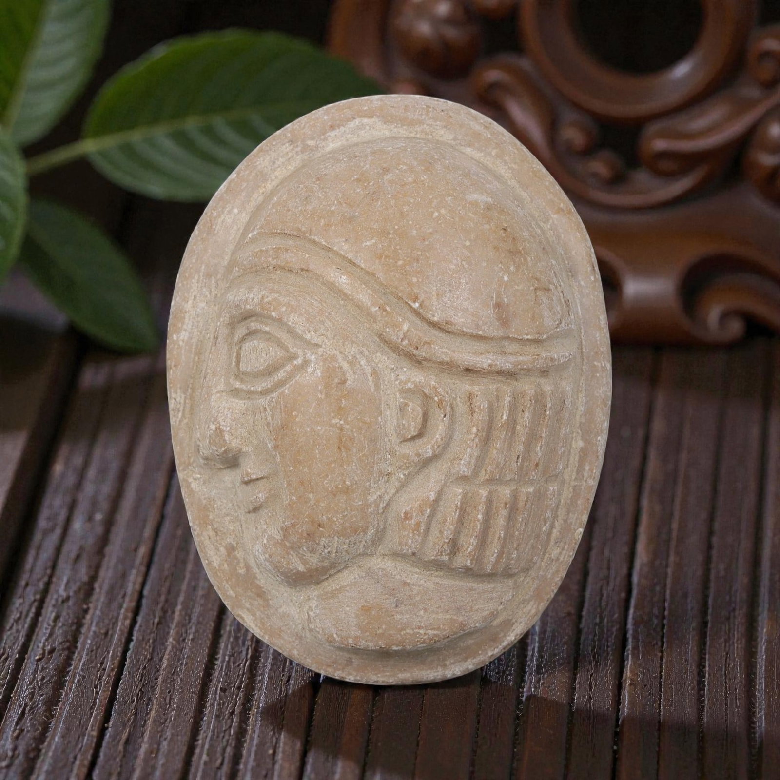Antique Egyptian Steatite Intaglio with Profile Head Motif, 35YD: This ancient intaglio is carved from weathered light brown steatite, with a smooth oval form. The flat face features a deeply engraved relief depicting a stylized human head in profile, showcasing def