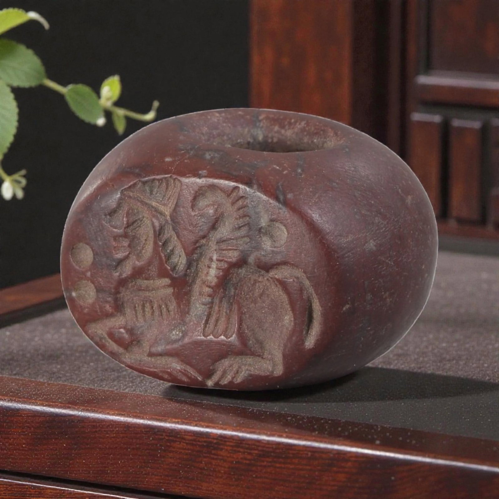 Ancient Sasanian Jasper Zoomorphic Stamp Seal, 69YD: This ancient stamp seal is carved from rich red-brown jasper, with a domed, barrel-shaped form and a central perforation for suspension. The flat face bears a deeply engraved intaglio depicting a comp