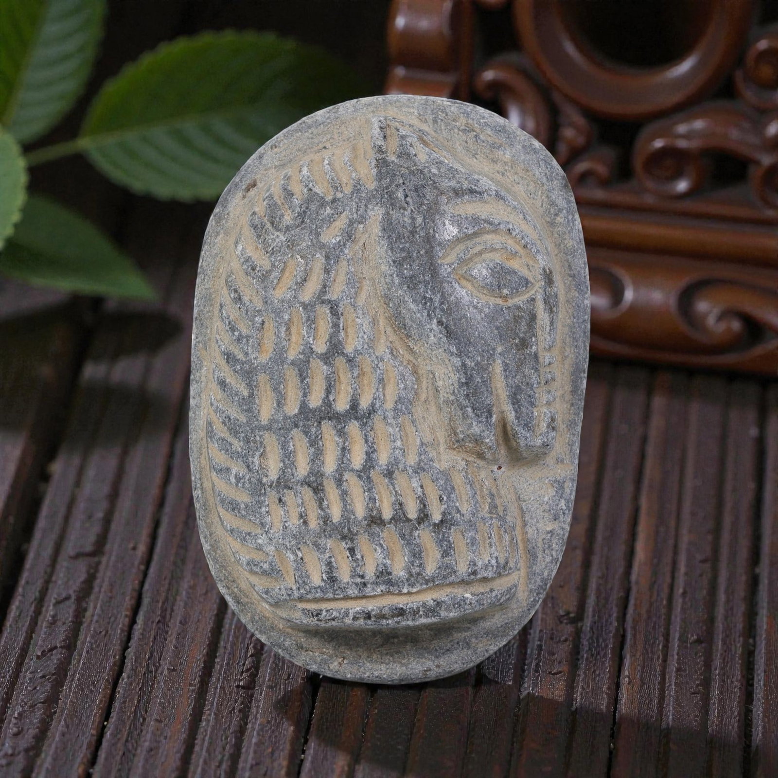 Antique Egyptian Schist Intaglio with Profile Head Motif, 42YD: This ancient intaglio is carved from weathered dark grey schist, with an oval form. The face features a deeply engraved relief depicting a stylized human head in profile, showcasing defined facial fea