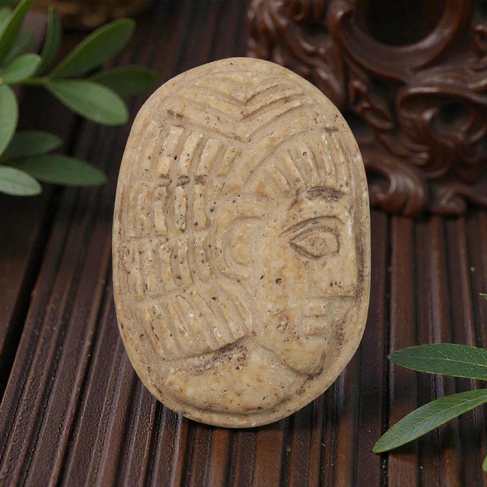 Antique Egyptian Steatite Intaglio with Profile Head Motif, 37YD: This ancient intaglio is carved from weathered light tan steatite, with an oval form. The face features a deeply engraved relief depicting a stylized human head in profile, showcasing defined facial f