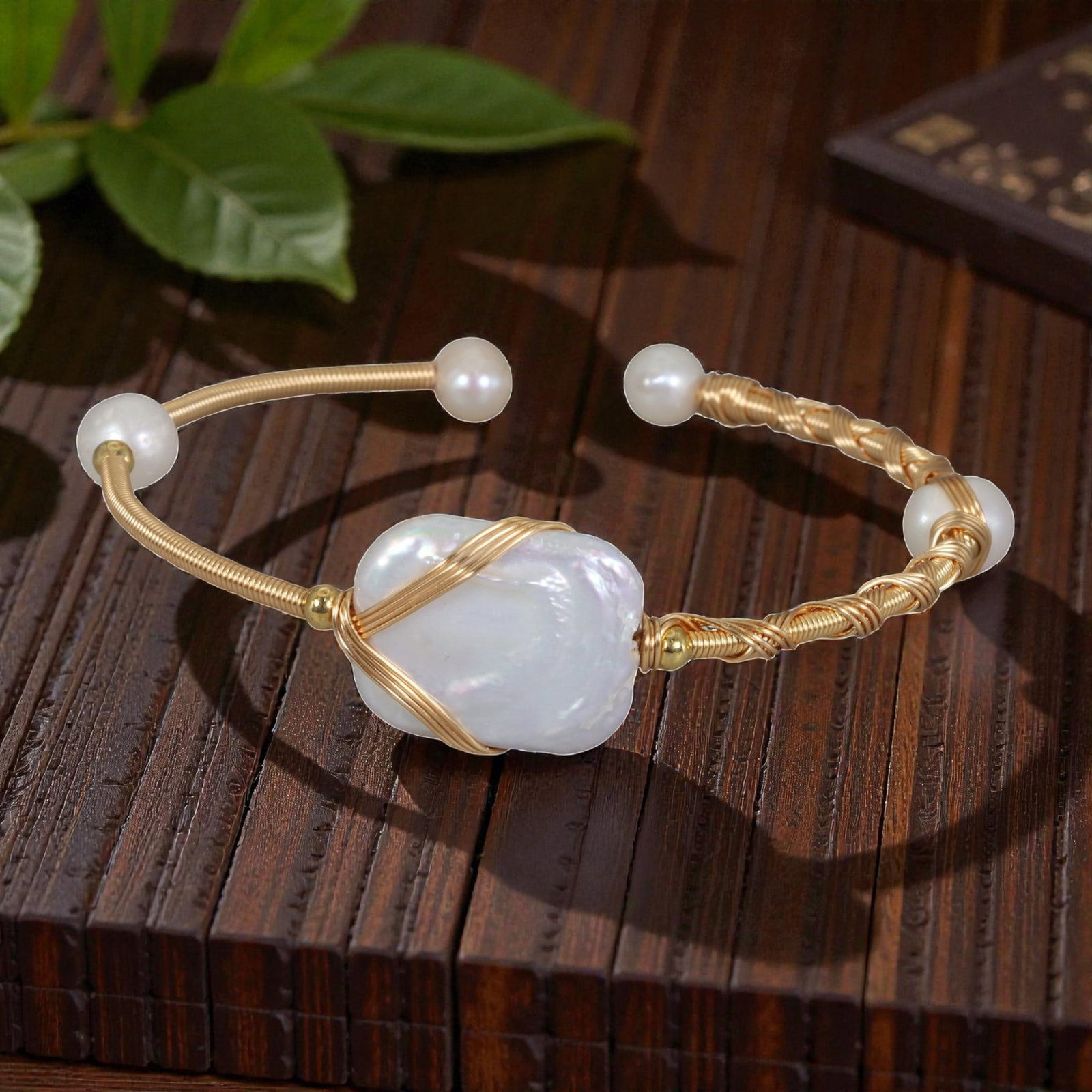 Natural Freshwater Baroque Pearl Gold Wire-Wrapped Open Cuff Bracelet, 6EB: A handcrafted open cuff bracelet made with gold-toned wire, featuring a large natural freshwater baroque pearl at the center secured by simple crisscross wire wrapping. The cuff includes braided wire 
