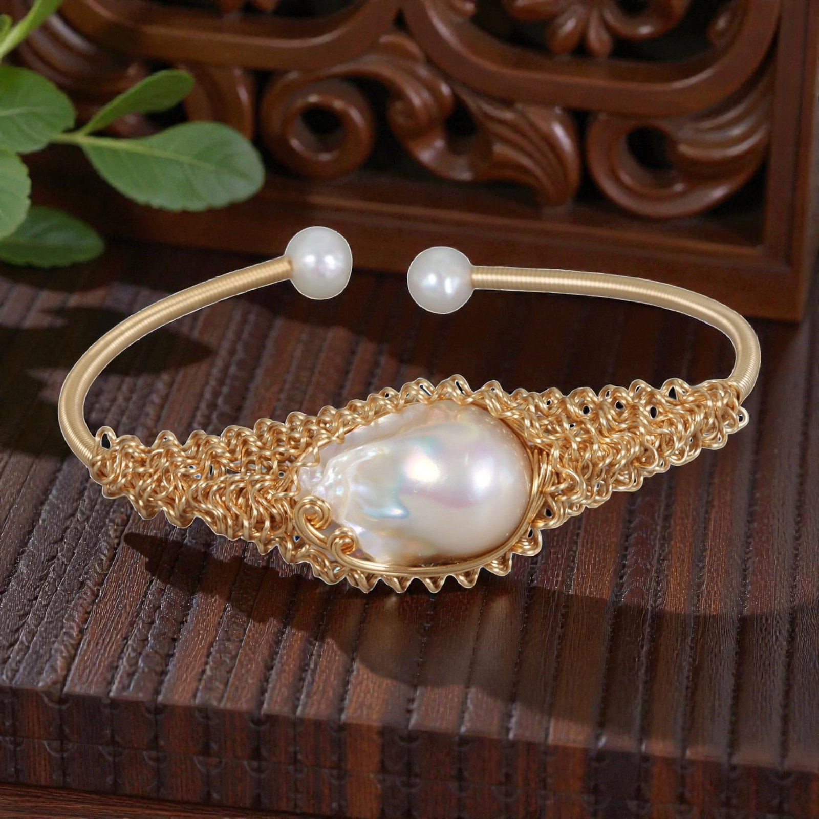 Natural Freshwater Baroque Pearl Gold Wire-Woven Open Cuff Bracelet, 26EB: A handcrafted open cuff bracelet made with gold-toned wire, intricately woven around a large natural freshwater baroque pearl at the center. The pearl is set within a delicate, lace-like wire frame, c
