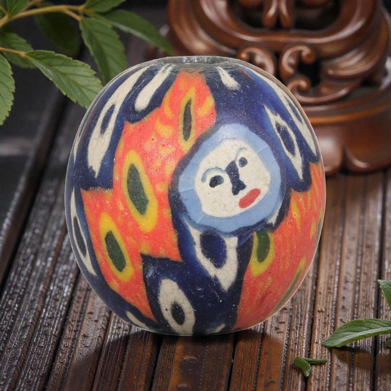 Antique Glass Bead - Islamic Jatim Indigo Swirl Eye Mosaic, 59YH: A spherical glass bead of Islamic Jatim type, crafted from polychrome mosaic glass. The surface features repeating concentric eye motifs with dark centers and white fringed borders, set against a swir