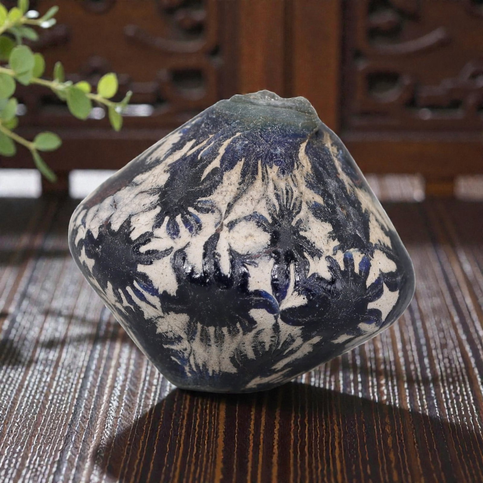 Antique Glass Bead - Islamic Jatim Biconical Indigo Floral Mosaic, 59AP: A biconical glass bead of Islamic Jatim type, crafted from polychrome mosaic glass. The surface features a repeating indigo floral motif, with deep blue stylized floral elements set against an opaque 