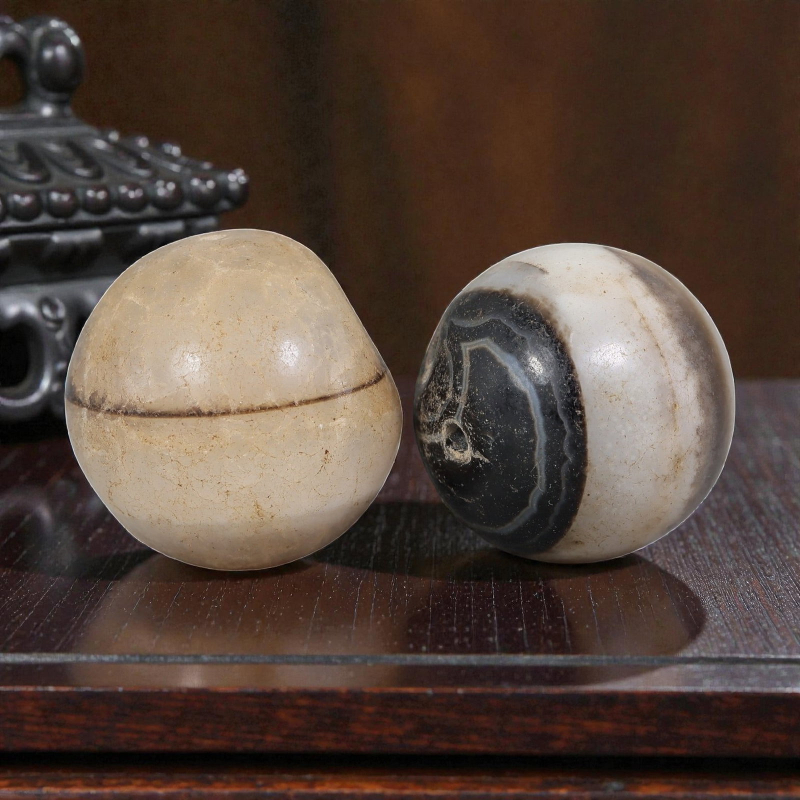 Antique Tibetan Agate Bead Pair - Banded Guru Dzi Beads, 57EB: These paired beads are crafted from natural banded agate, exhibiting distinct linear and concentric banding patterns. The surfaces display fine cracking, natural patina, and smooth wear consistent wit