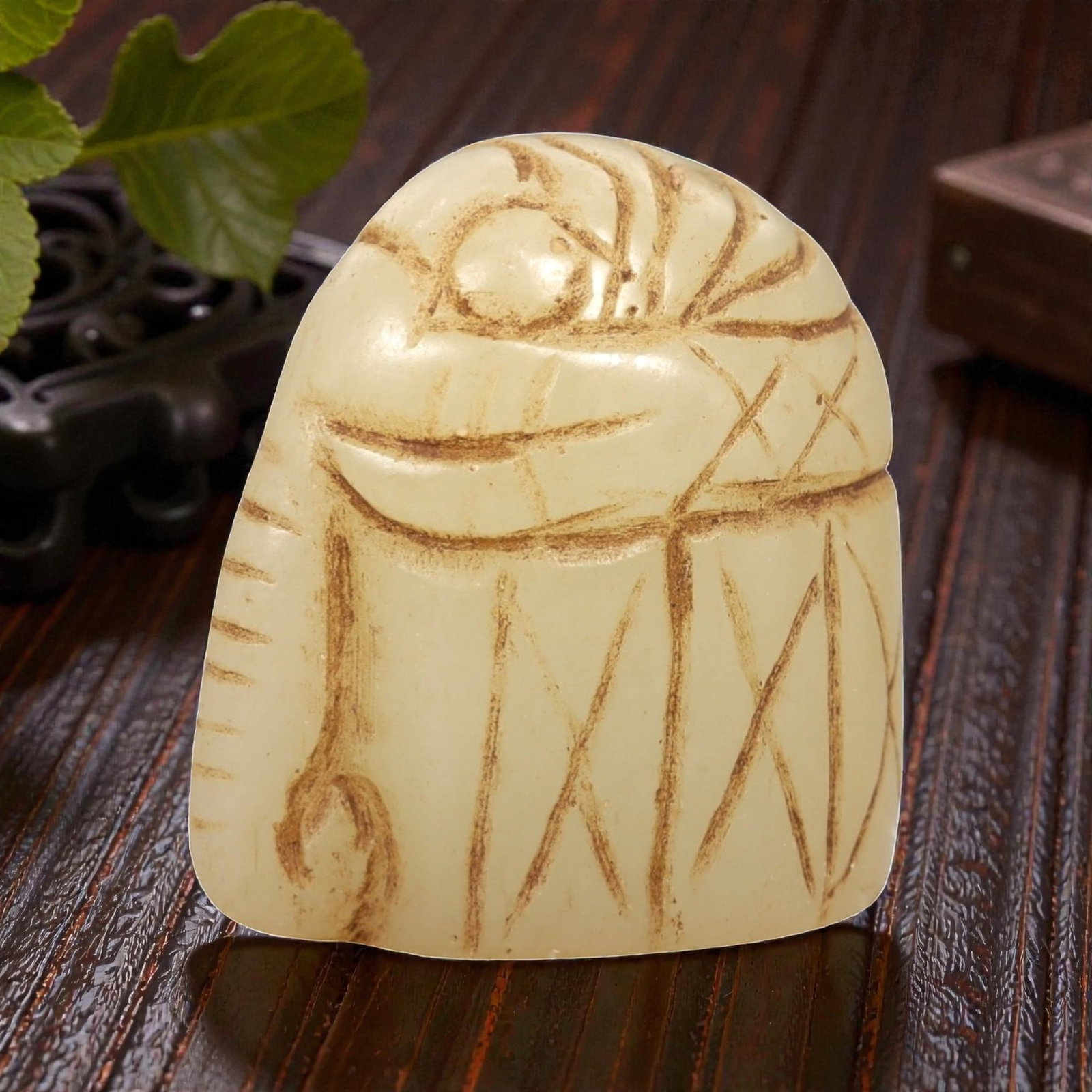 Ancient Serpentine Elephant - Near Eastern Figurine, 67AL: This artifact is carved from serpentine, depicting a stylized elephant form with a compact, rounded body and incised decorative motifs including linear and cross-hatch patterns on the surface. The car