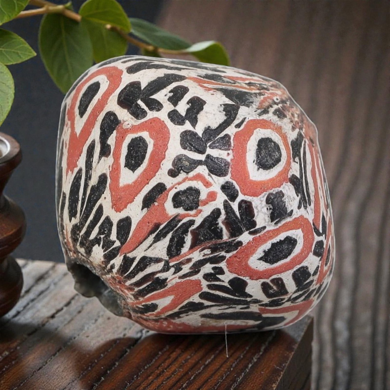 Antique Glass Bead - Islamic Jatim Red-Black-White Eye Mosaic, 53YH: A rounded, irregular glass bead of Islamic Jatim type, crafted from polychrome mosaic glass. The surface features bold eye motifs with black centers framed by red rings, interspersed with black feathe
