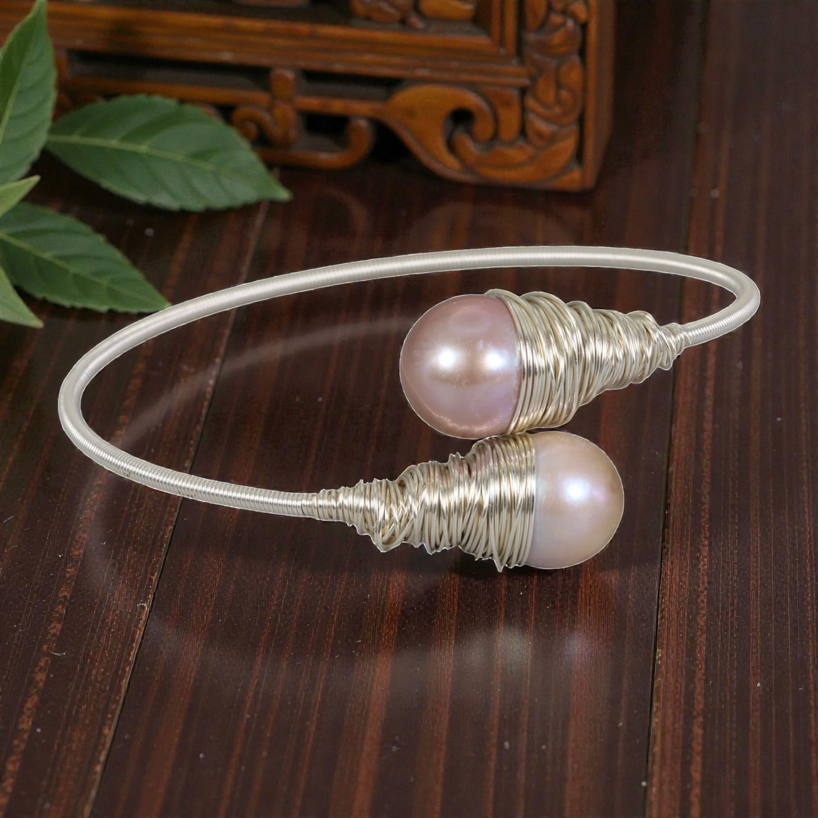 Natural Pink Freshwater Pearl Silver Tone Wire-Wrapped Open Cuff Bracelet, 28EB: A delicate open cuff bracelet handcrafted with silver-toned wire, featuring two soft pink freshwater pearls at the open ends, each encased in intricate wire-wrapped cone settings. The wire is coiled i