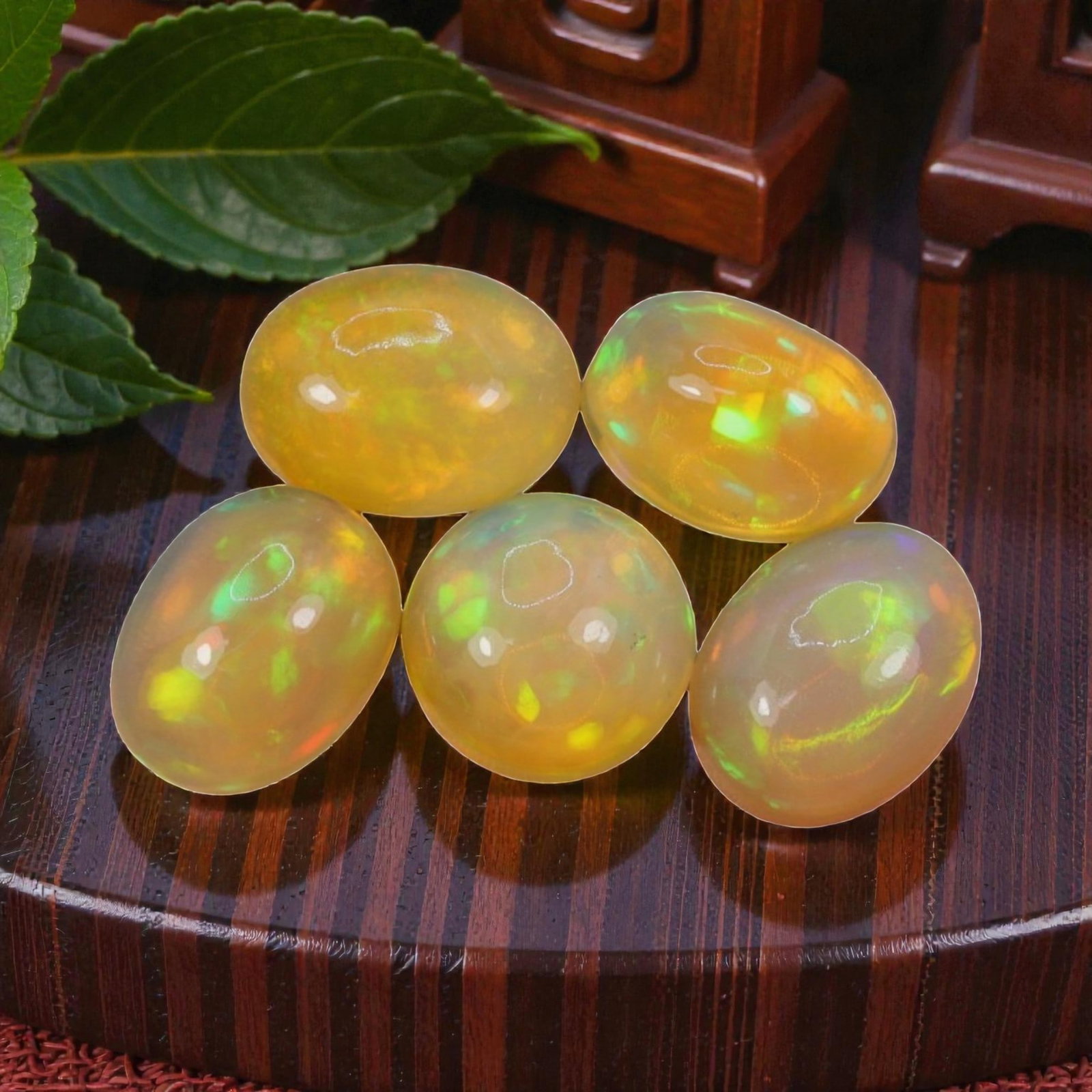 6.27 Carats Welo Opal Oval Cabochon Parcel - Natural Ethiopian Stones, 52WD: This luminous parcel of five Welo opals showcases a warm, honey-toned base with vivid, shifting flashes of lime green, golden yellow, and subtle orange across each stone. The total carat weight of the