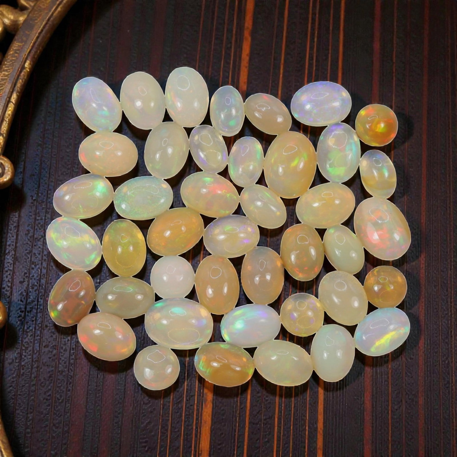 20.74 Carats Welo Opal Cabochon Parcel - Natural Ethiopian Stones, 47XA: This vibrant collection of Welo opals features a stunning variety of translucent body tones, from milky white and soft cream to warm honey and golden-orange, each adorned with vivid, shifting color pl
