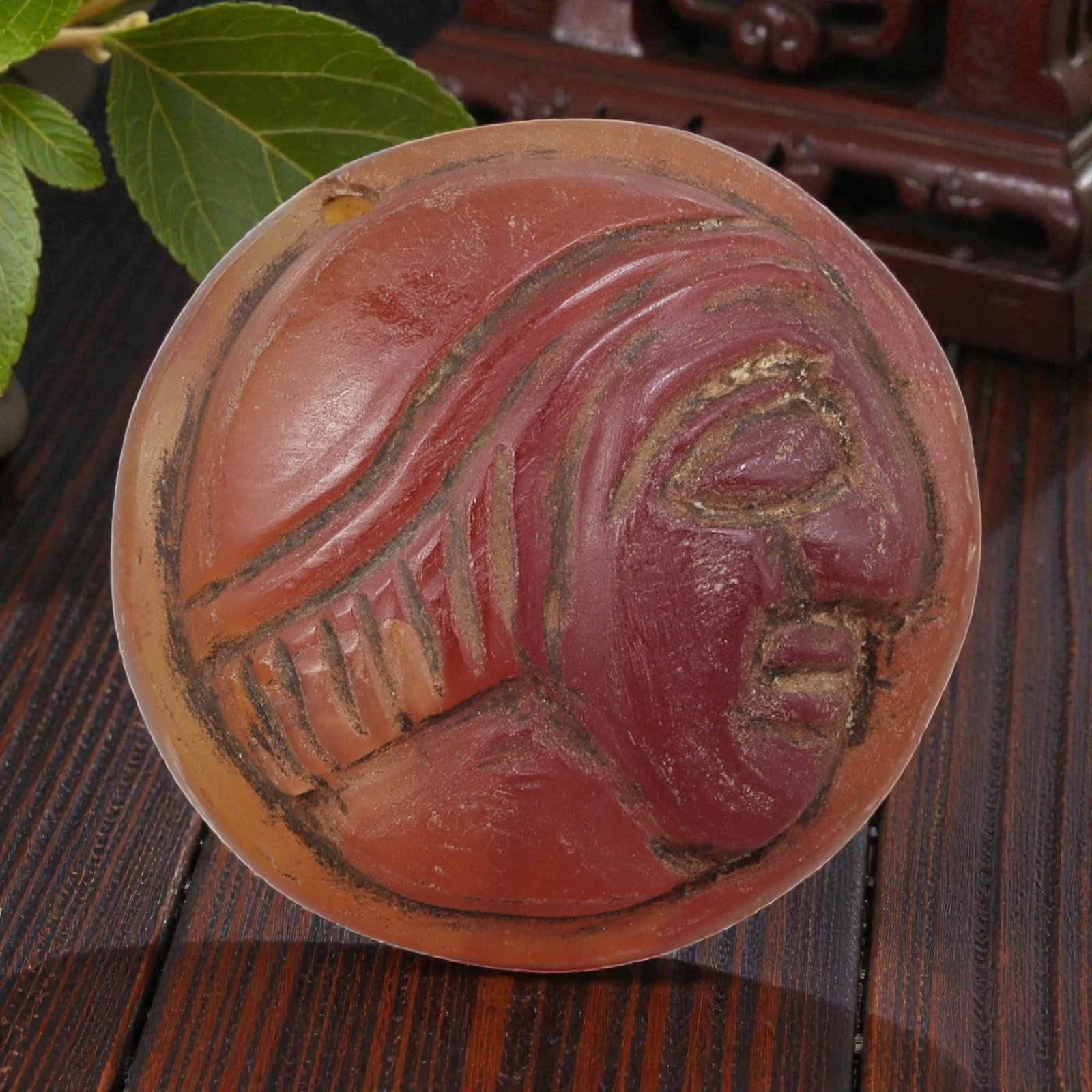 Antique Egyptian Carnelian Intaglio with Profile Head Motif, 96AN: Carved from carnelian with rich reddish-orange coloration, the oval-shaped intaglio features an incised profile head of a figure wearing a detailed headdress. The carving includes defined facial featu