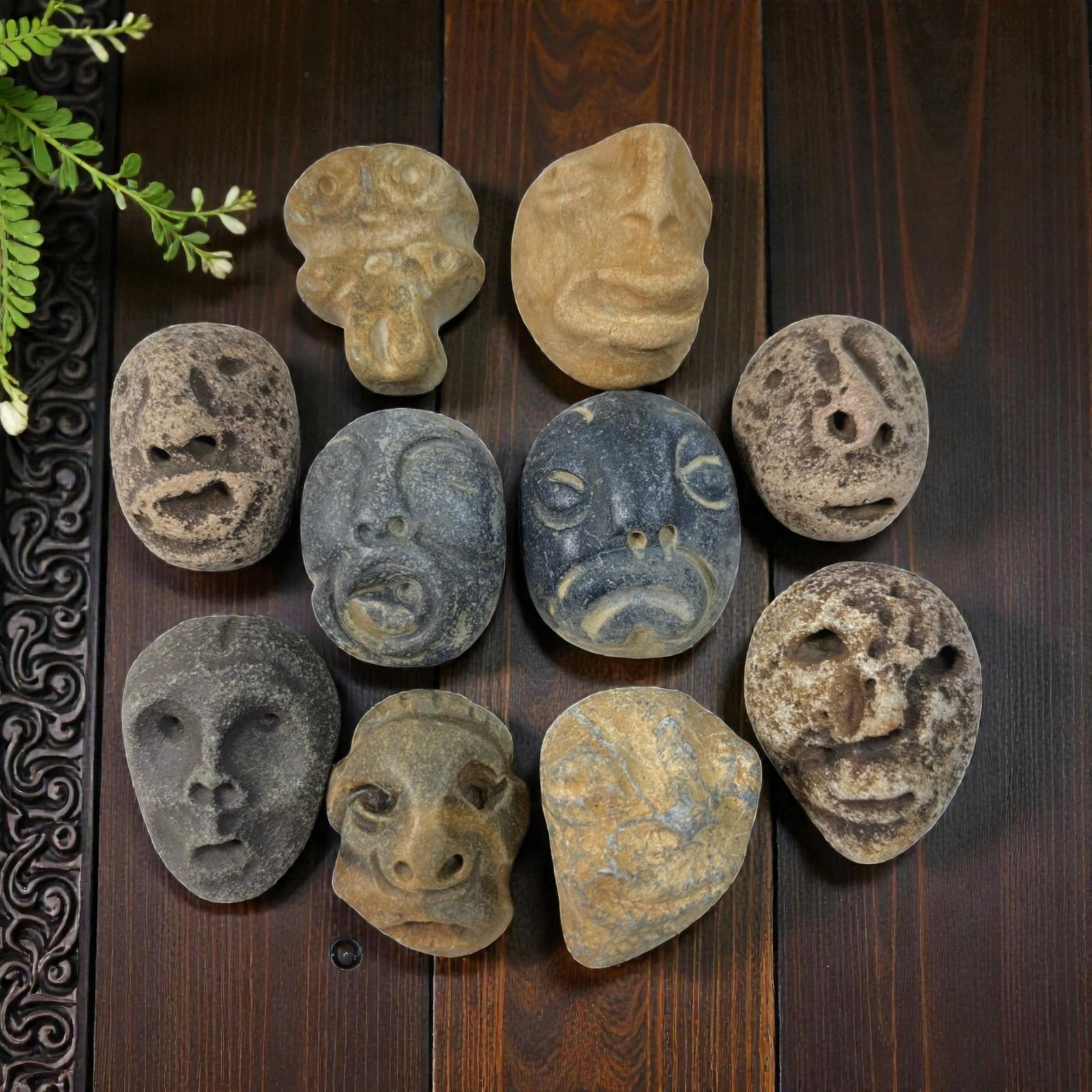 A Lot of 10 Ancient Medieval Stone Maskette Amulets, 4AB: The group comprises ten carved stone maskette amulets, each depicting stylized human or zoomorphic faces. The pieces are rendered in varied styles, some with deeply carved features and others with sch
