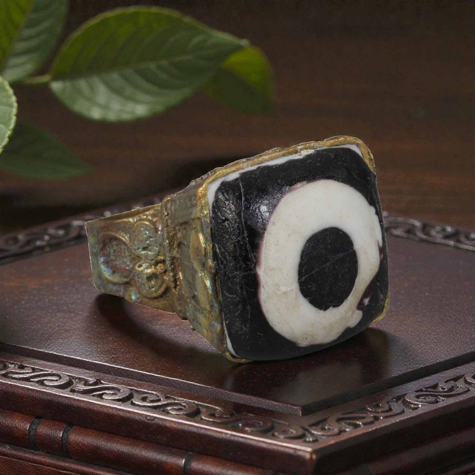 Antique Qajar Dynasty Gilt Evil Eye Ring, US Size 9.5, 43AJ: A gilt-metal ring of the Qajar period, US ring size 9.5, featuring a large square evil-eye glass inlay with a bold concentric black-and-white design (the glass exhibits age-related cracks). The bezel 