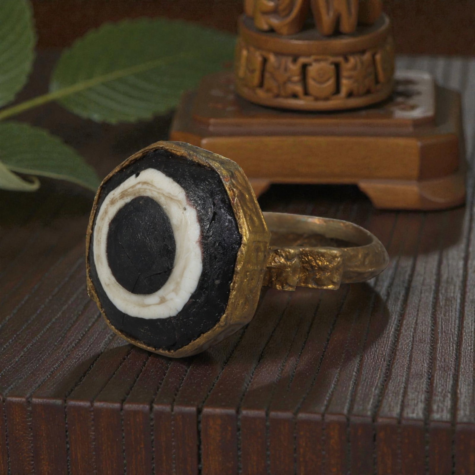 Antique Qajar Dynasty Gilt Evil Eye Ring, US Size 9.5, 16AJ: A gilt-metal ring of the Qajar period, US ring size 9.5, featuring an octagonal evil-eye glass inlay with a bold concentric black-and-white design (the glass exhibits age-related cracks). The bezel is