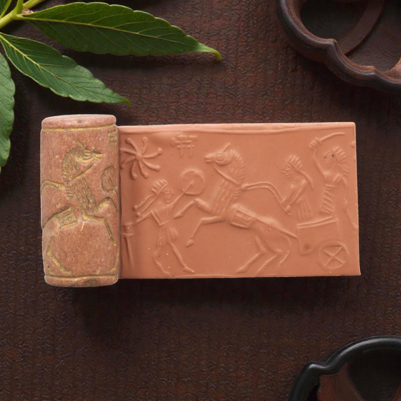 Ancient Steatite Cylinder Seal - Mesopotamian Chariot Combat Scene, 95ZR: Carved from dense steatite, this ancient Mesopotamian cylinder seal features a dynamic linear relief composition of a chariot and warrior figures in combat, executed in the characteristic glyptic styl