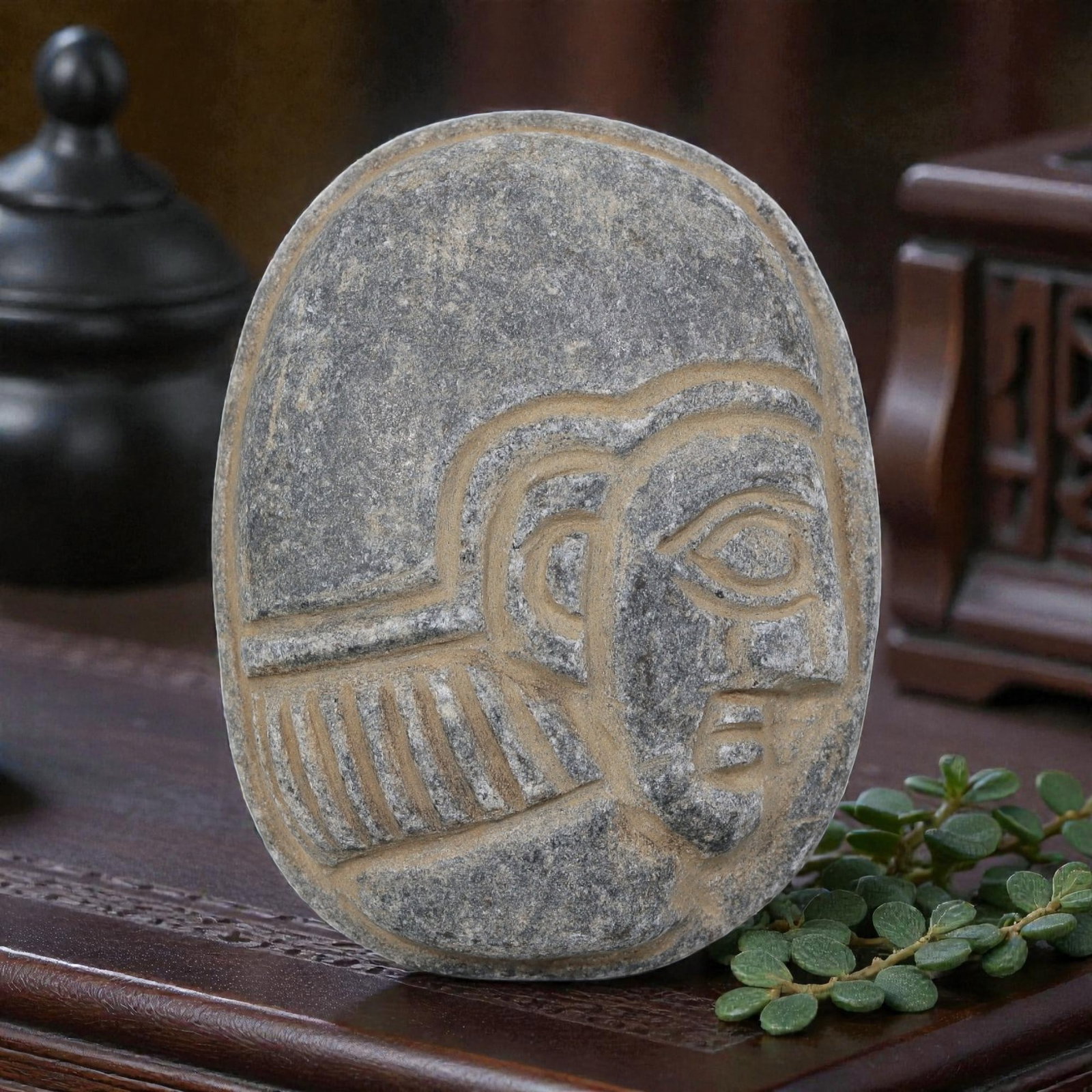 Antique Egyptian Schist Intaglio with Profile Head Motif, 34AP: Carved from dark grey schist, this oval intaglio depicts a stylized human head in profile, with simplified linear patterns defining the headdress and hairstyle, alongside clearly incised facial featur
