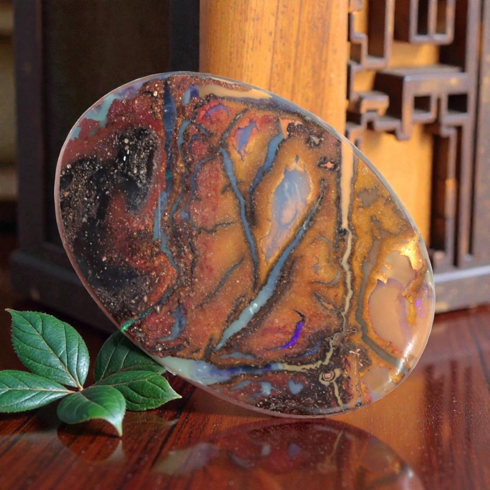 3.87 Carats Multi-Color Koroit Boulder Opal - Natural Australian Stone, LZ43: This stunning 3.87 carat Koroit boulder opal, measuring 14.8mm x 10.4mm x 2.7mm, is a breathtaking canvas of natural color and pattern. Polished into a smooth oval cabochon, its face is dominated by r