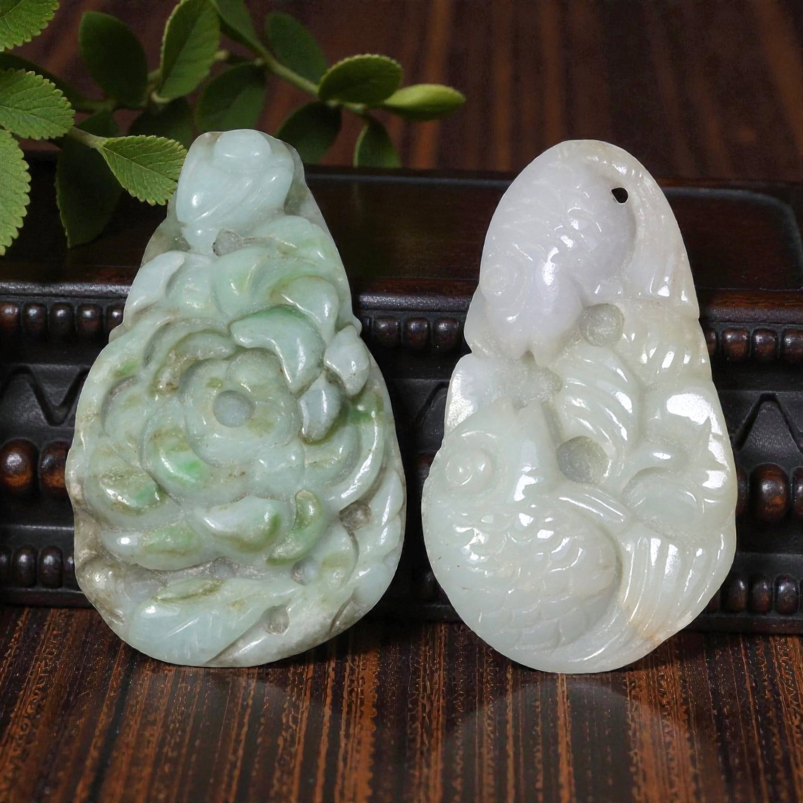 Lot of 2 Vintage Oriental Chinese Jadeite Jade Pendants, 27AG: The lot comprises two teardrop-shaped jadeite pendants. The left pendant is carved from mottled pale green jadeite with natural inclusions, featuring a high-relief flower motif with layered petals, a 