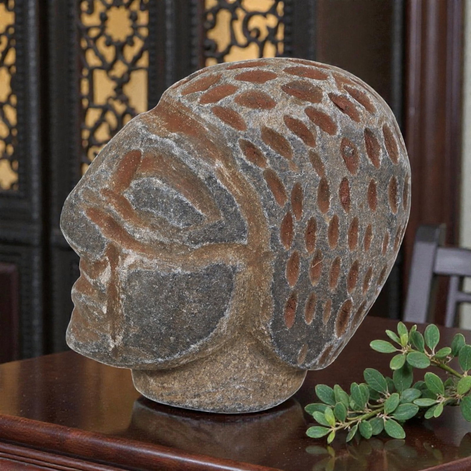 Antique Islamic Carved Stone Head, 61YD: This carved head is crafted from weathered dark grey stone, depicting a stylized human head in profile. The surface features incised and relief details defining the almond-shaped eye, simplified nose,
