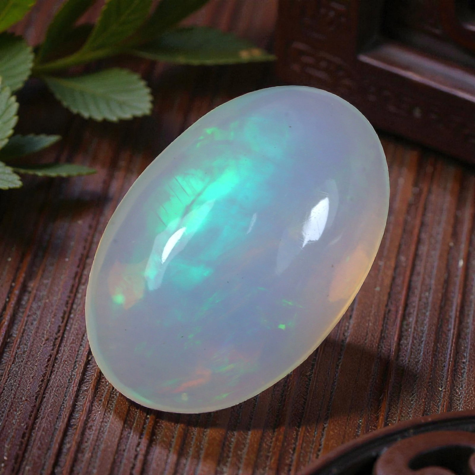 4.95 Carats Welo Opal Oval Cabochon - Natural Ethiopian Stone, 74XB: This beautiful oval cabochon of Welo opal features a soft, ethereal play of color, dominated by luminous turquoise and green flashes with subtle hints of warm peach across its milky, translucent base.