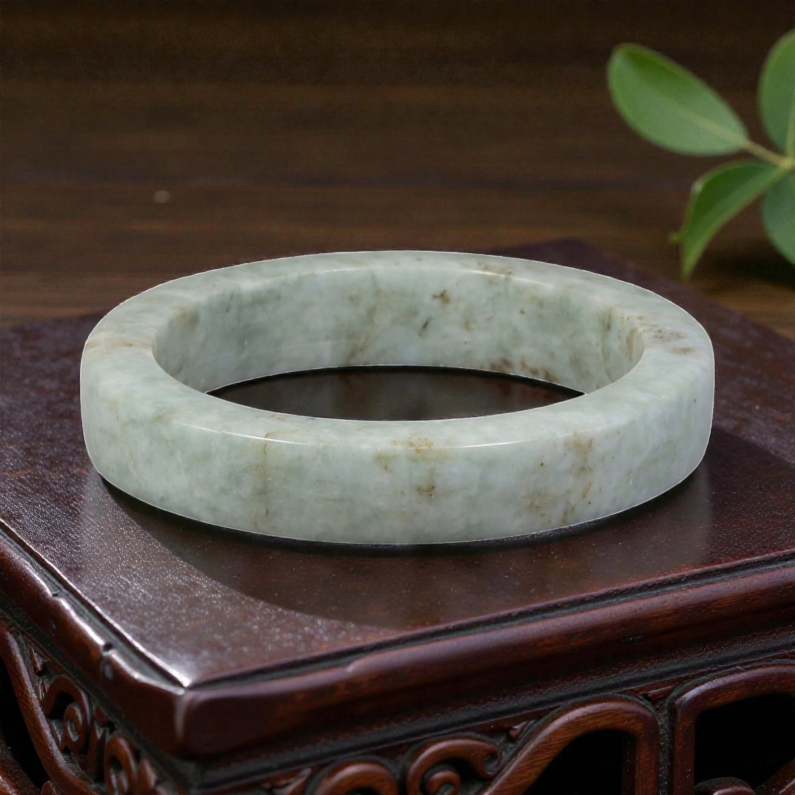 Natural Burmese Type A Light Green Jadeite Bangle - Earthy Speckle Bracelet, 22EA: This is a wide, square-profile bangle crafted from natural Burmese Type A jadeite, displaying a soft light green base with subtle earthy brown speckles and natural veining throughout the polished ston