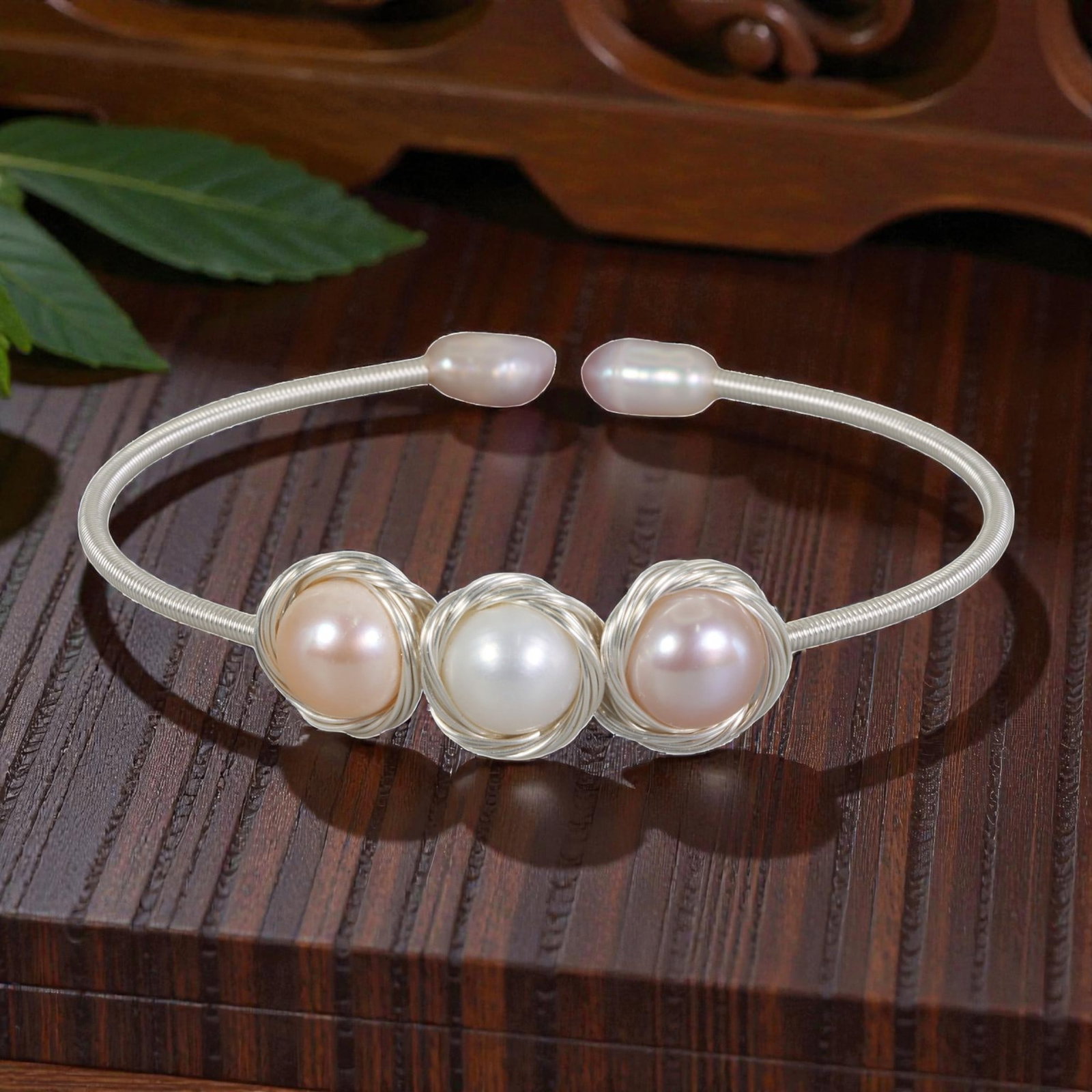 Natural Freshwater Pearl Silver Tone Wire-Wrapped Open Cuff Bracelet, 29EB: A delicate open cuff bracelet handcrafted with silver-toned wire, featuring three natural freshwater pearls at the center, two soft pink pearls flanking a single white pearl-each encased in an intrica