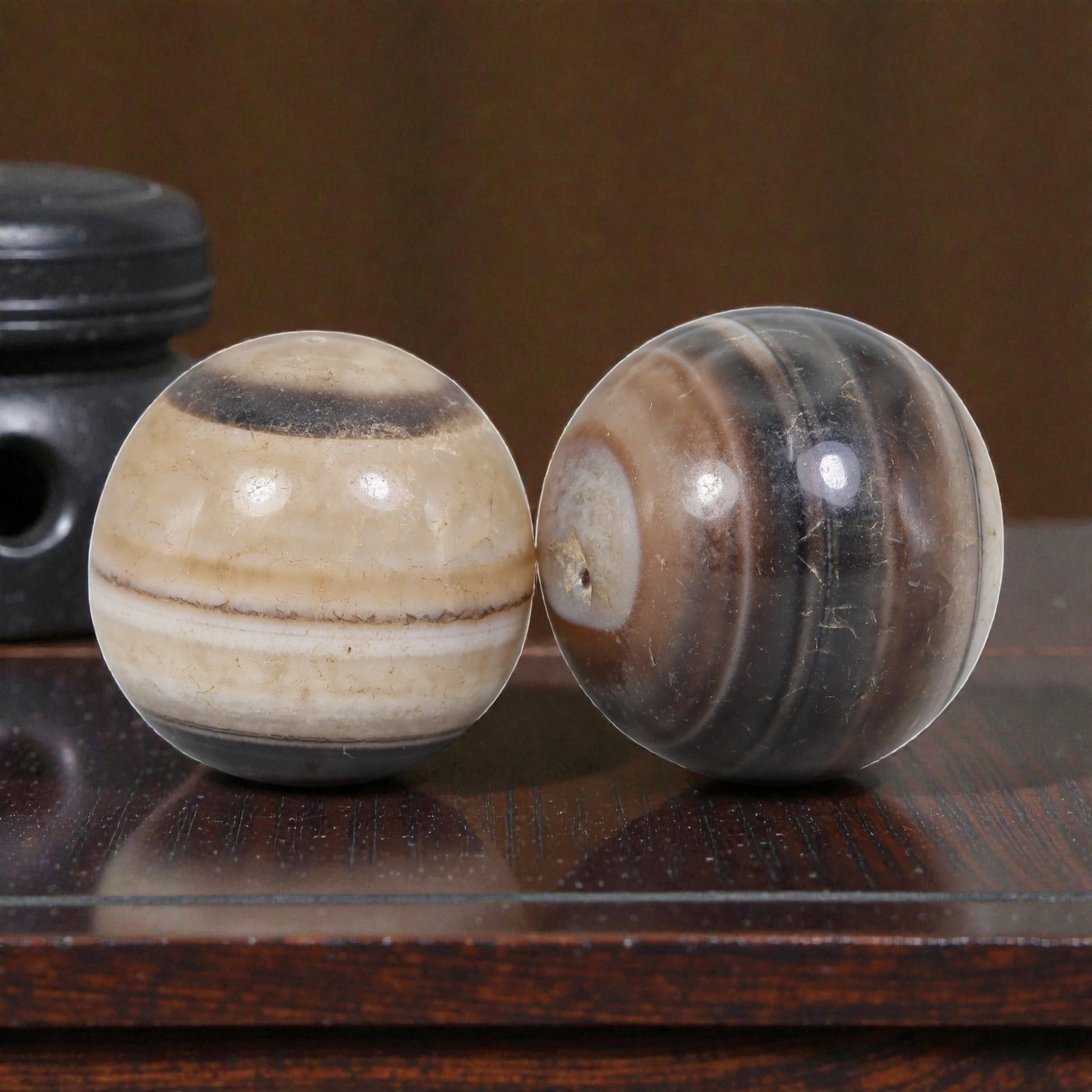 Antique Tibetan Agate Bead Pair - Banded Guru Dzi Beads, 61EB: These paired beads are crafted from natural banded agate, exhibiting distinct concentric striations and earthy tonal variations. The surfaces display fine cracking, natural patina, and smooth wear con