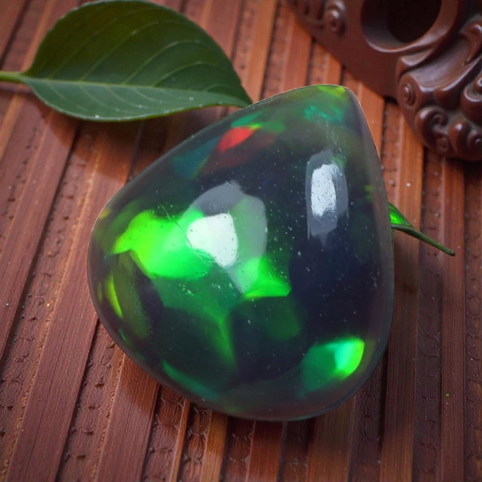 0.88 Carats Ethiopian Welo Black Opal Freeform Cabochon - Natural Loose Gemstone, 83XB: This captivating Ethiopian Welo black opal features a deep, translucent base that serves as a dramatic backdrop for its exceptional play-of-color. The smooth, polished freeform cabochon surface showca