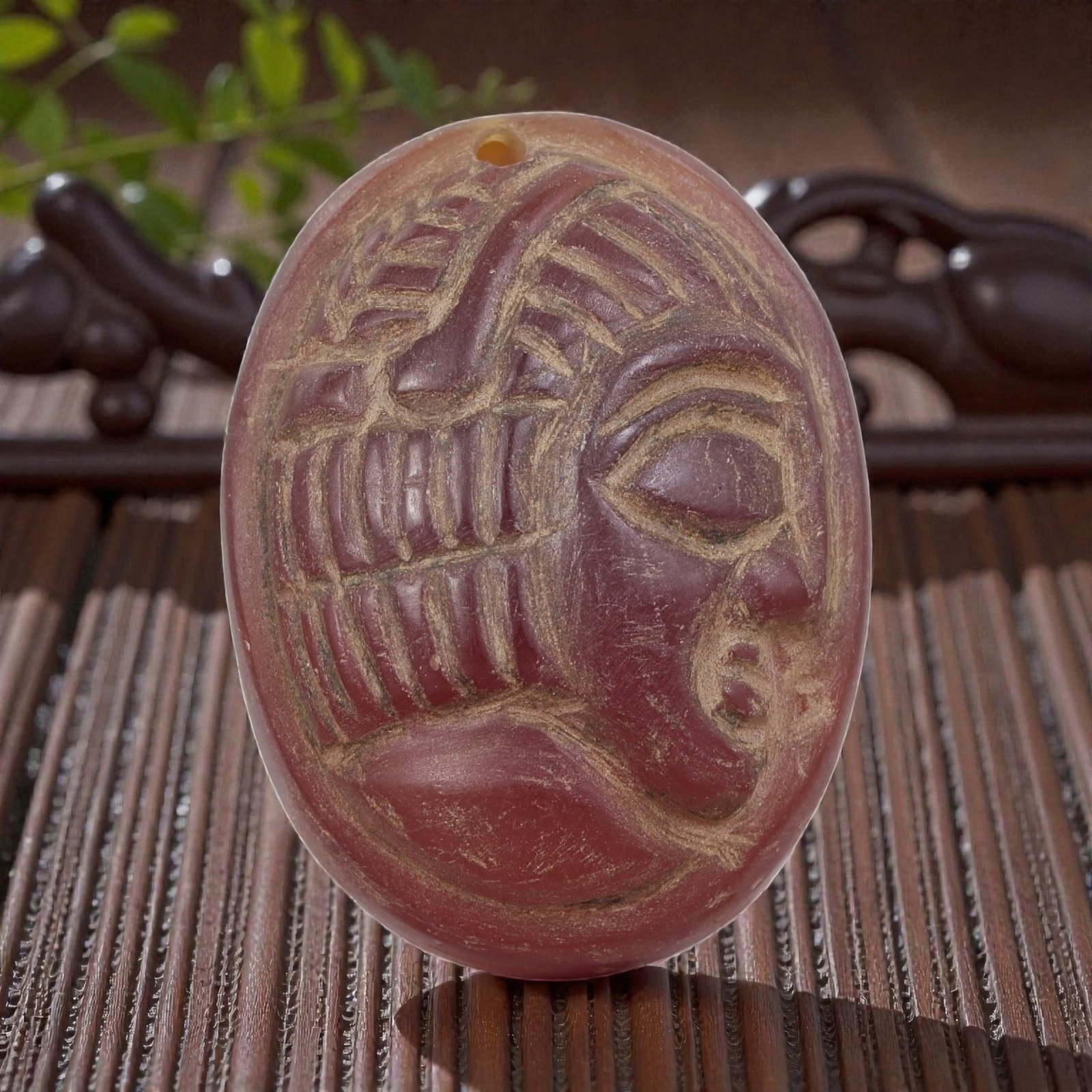 Antique Egyptian Carnelian Intaglio with Profile Head Motif, 95AN: Carved from carnelian with rich reddish-orange coloration, the oval-shaped intaglio features an incised profile head of a figure wearing a detailed headdress. The carving includes defined facial featu