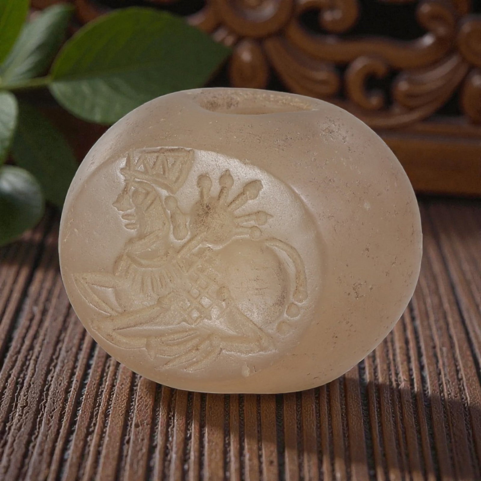 Ancient Sasanian Chalcedony Zoomorphic Stamp Seal, 73YD: This ancient stamp seal is carved from translucent chalcedony, with a domed, barrel-shaped form and a central perforation for suspension. The flat face features a deeply engraved intaglio depicting a 