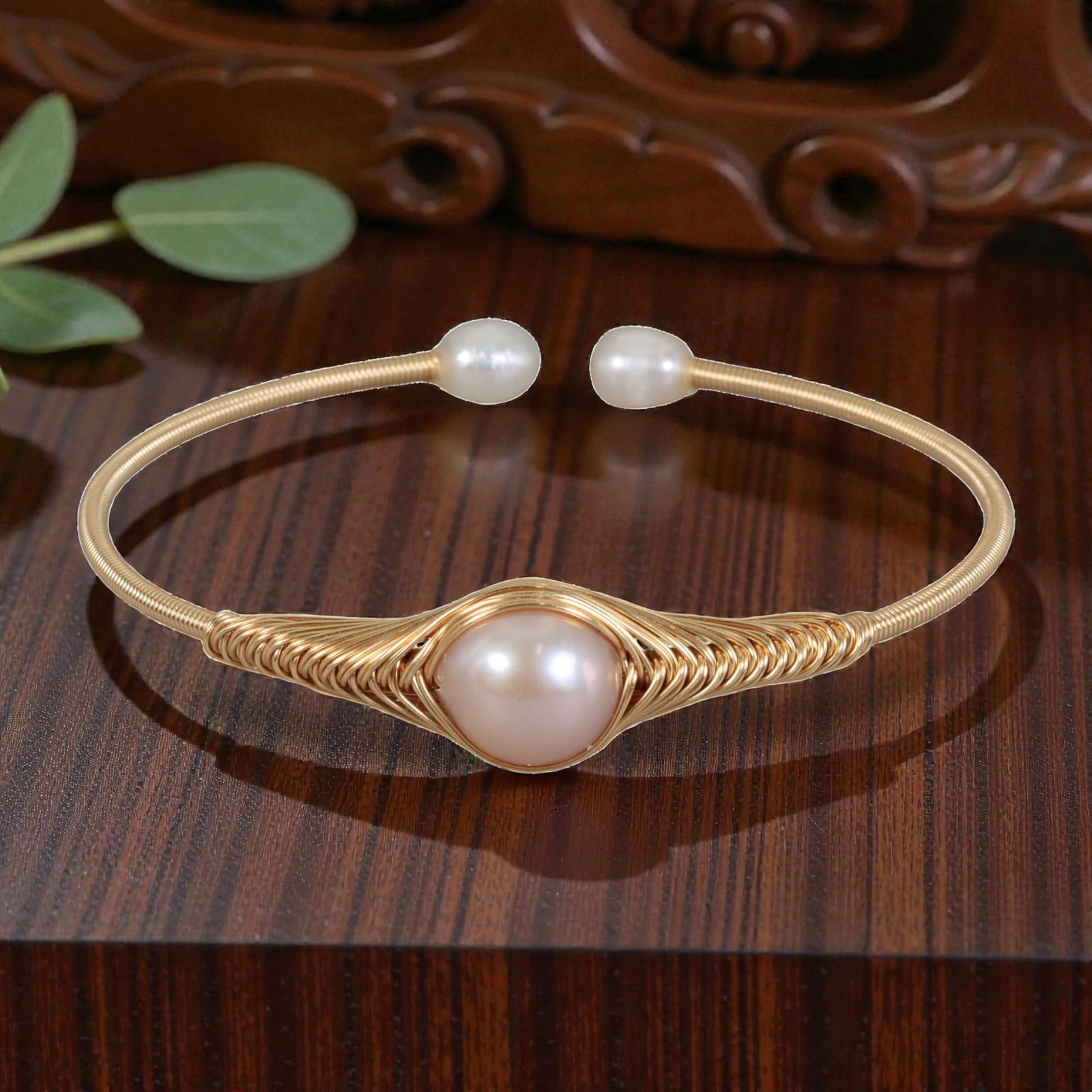Natural Light Pink Freshwater Pearl Gold Wire-Wrapped Open Cuff Bracelet, 18EB: A handcrafted open cuff bracelet made with gold-toned wire, intricately woven around a large round natural light pink freshwater pearl at the center. The wire is coiled in a decorative fan-like patter