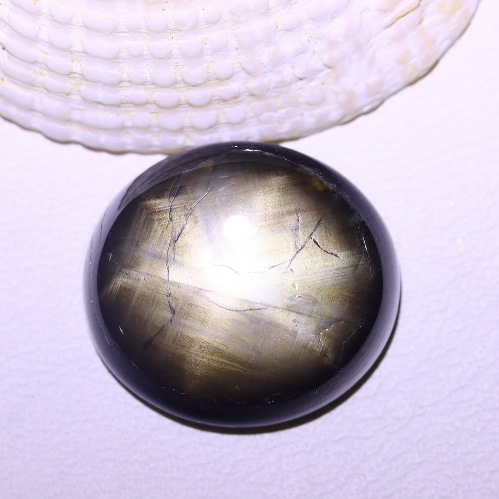 17.59cts 6 Rays Black Star Sapphire , 495E: Ksmith Heritage Auctioneers Subject: Natural 6 Rays Star Sapphire Origin: Myanmar Carat Weight: 17.59cts Dimension: 17.2x15.5x5.4 mm Treatment: Diffusion Type: Cabochon, P
