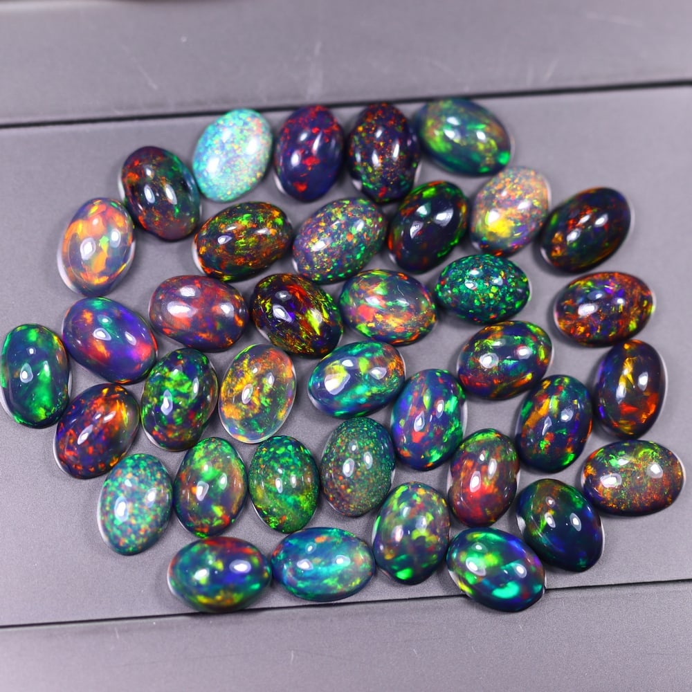 *19.57Ct 7x5mm Smoked Welo Opal Lot - Ethiopian Opal, 363C: Ksmith Heritage Auctioneers Subject: Natural Ethiopian Welo Opal Origin: Ethiopia Carat Weight: 19.57Ct Dimension: 7x5x2.4 mm Treatment: Smoked Type: Cabochon, Polished