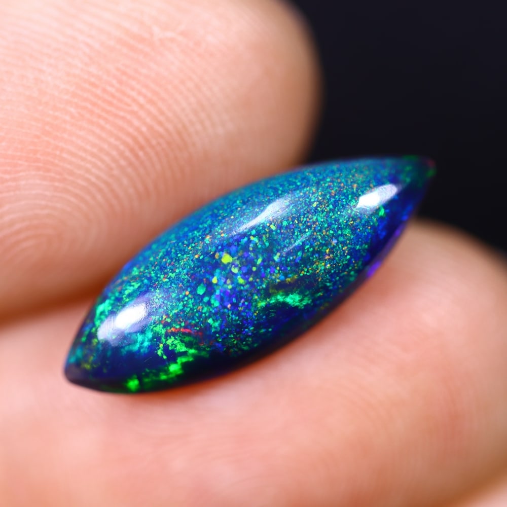 *2.77Ct Smoked Welo Opal Polished - Ethiopian Opal , 314C: Ksmith Heritage Auctioneers Subject: Natural Ethiopian Welo Opal Origin: Ethiopia Carat Weight: 2.77Ct Dimension: 18.1x6.9x4.7 mm Treatment: Smoked Type: Cabochon, Polishe