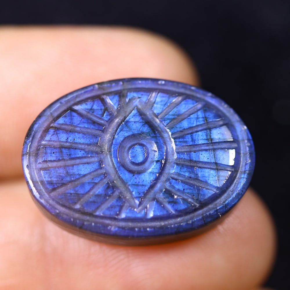 21.06cts Labradorite Evil Eye - Carving , 823E: Ksmith Heritage Auctioneers Subject: Natural Labradorite Origin: India Carat Weight: 21.06cts Dimension: 23x16.3x5.6 mm Treatment: Unheated Type: Carving