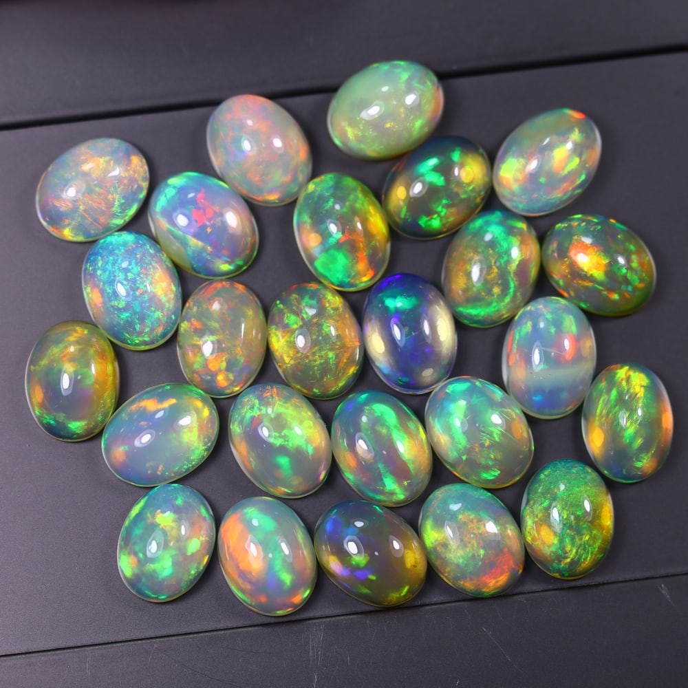 *21.44Ct 8x6mm Welo Opal Lot - Ethiopian Opal, 365C: Ksmith Heritage Auctioneers Subject: Natural Ethiopian Welo Opal Origin: Ethiopia Carat Weight: 21.44Ct Dimension: 8x6x3.7 mm Treatment: Natural Untreated Type: Cabochon, Polis