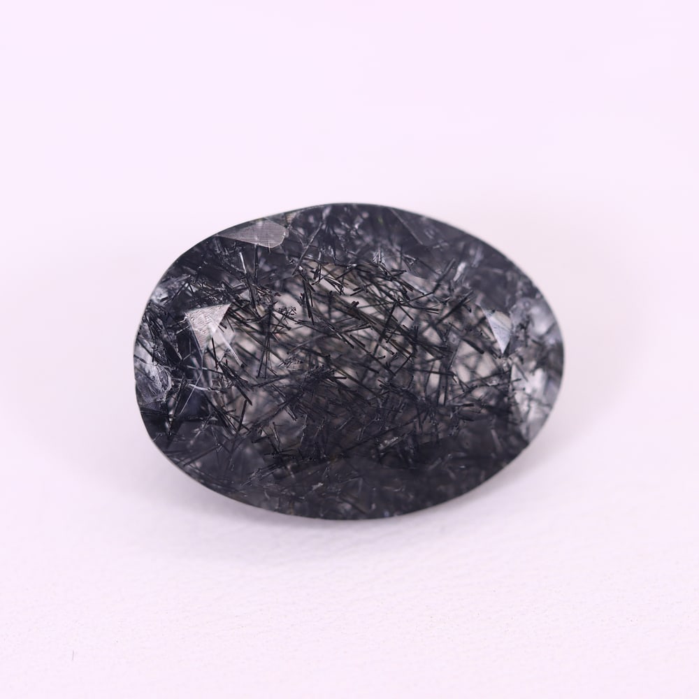 *12.63Ct Black Rutiled Quartz - Polished Faceted , 250C: Ksmith Heritage Auctioneers Subject: Natural Black Rutiled Quartz Carat Weight: 12.63 Ct Dimension: 18.6x13.7x8.1 mm