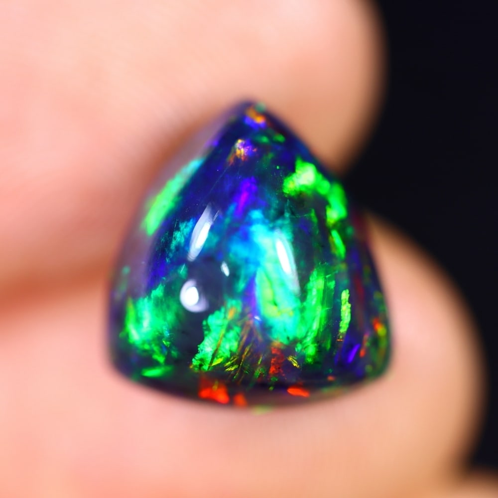 *4.76Ct Welo Black Opal Polished - Ethiopian Opal - Triangle Cabochon , 300E: Ksmith Heritage Auctioneers Subject: Natural Ethiopian Welo Black Opal Origin: Ethiopia Carat Weight: 4.76Ct Dimension: 12.5 x 11.7 x 7.6 mm Treatment: Smoked Shape: Trian