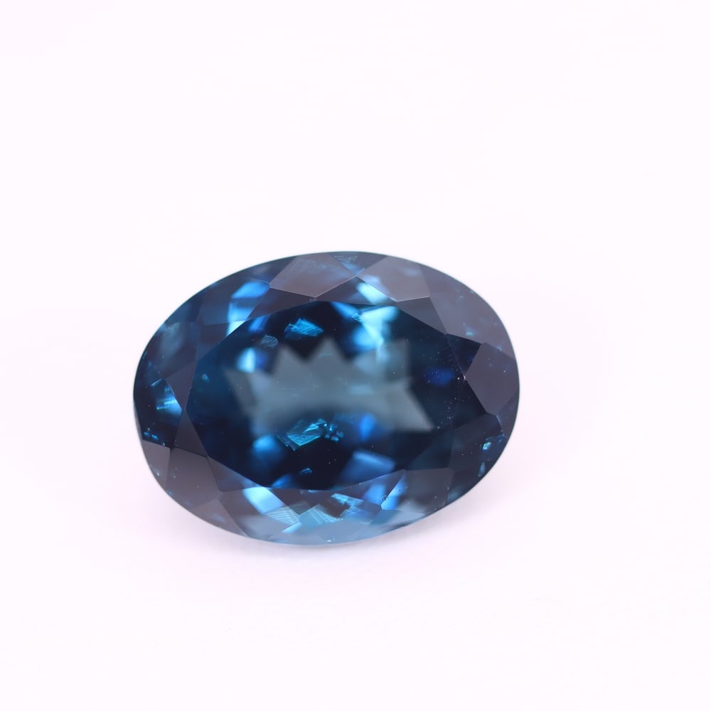 *13.84Ct London Blue Topaz - Polished Faceted , 214C: Ksmith Heritage Auctioneers Subject: Natural Blue Topaz Origin: Myanmar Carat Weight: 13.84Ct Dimension: 15.8x11.9x9.1 mm Treatment: Irridiated Type: Faceted, Polished