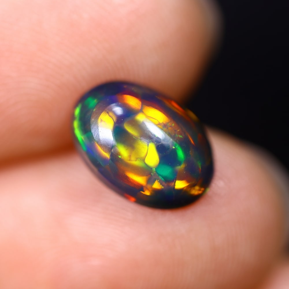 *1.66Ct Smoked Welo Opal Polished - Ethiopian Opal , 305C: Ksmith Heritage Auctioneers Subject: Natural Ethiopian Welo Opal Origin: Ethiopia Carat Weight: 1.66Ct Dimension: 11x7.8x3.9 mm Treatment: Smoked Type: Cabochon, Polished<