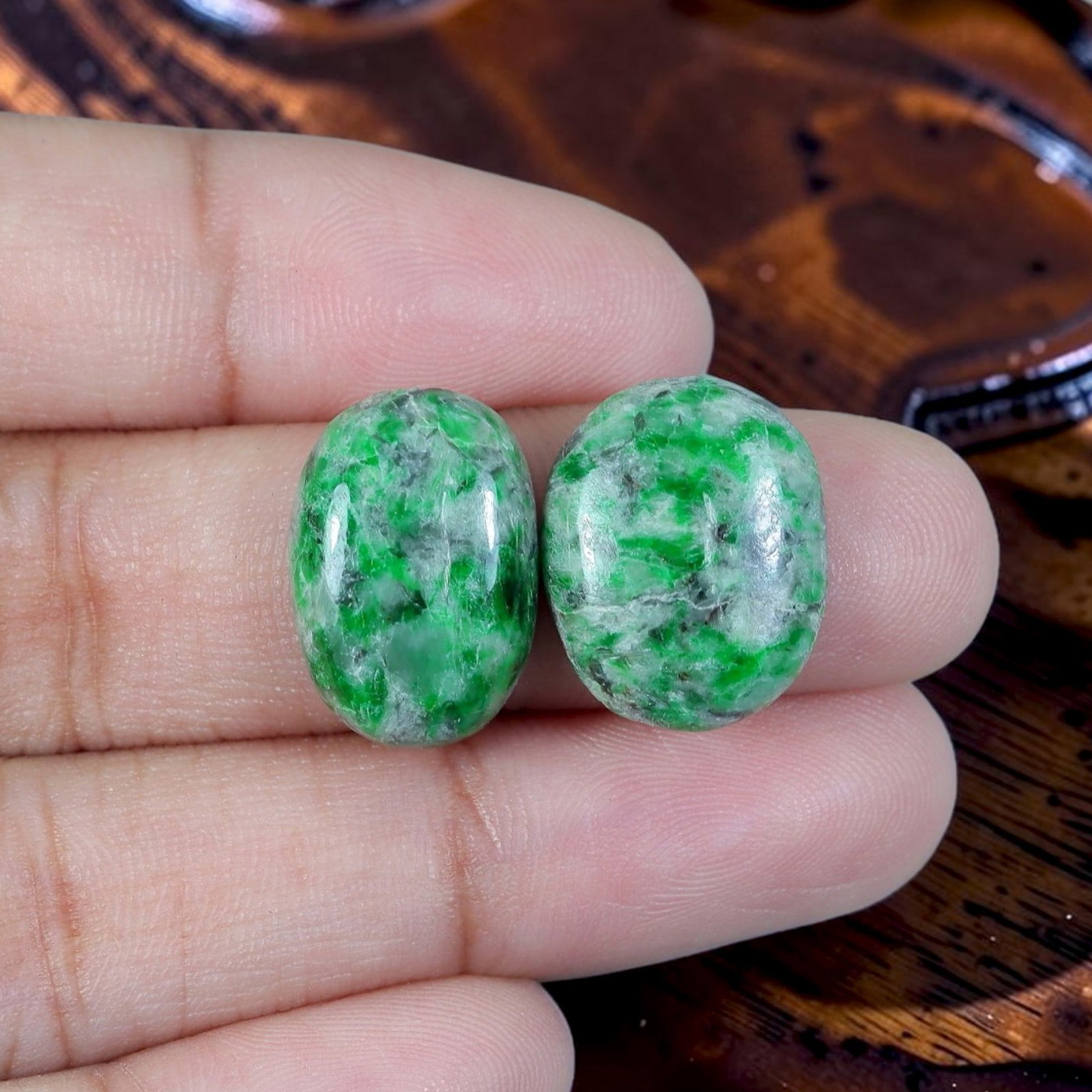 13.82ct Natural Burmese Type A Jadeite Jade Cabochon Pair, 15EC: Crafted as a matched pair from untreated natural Type A Burmese jadeite jade, each piece is finished as a smoothly domed oval cabochon with flat base suited for earring mounting. The mineral matrix fe