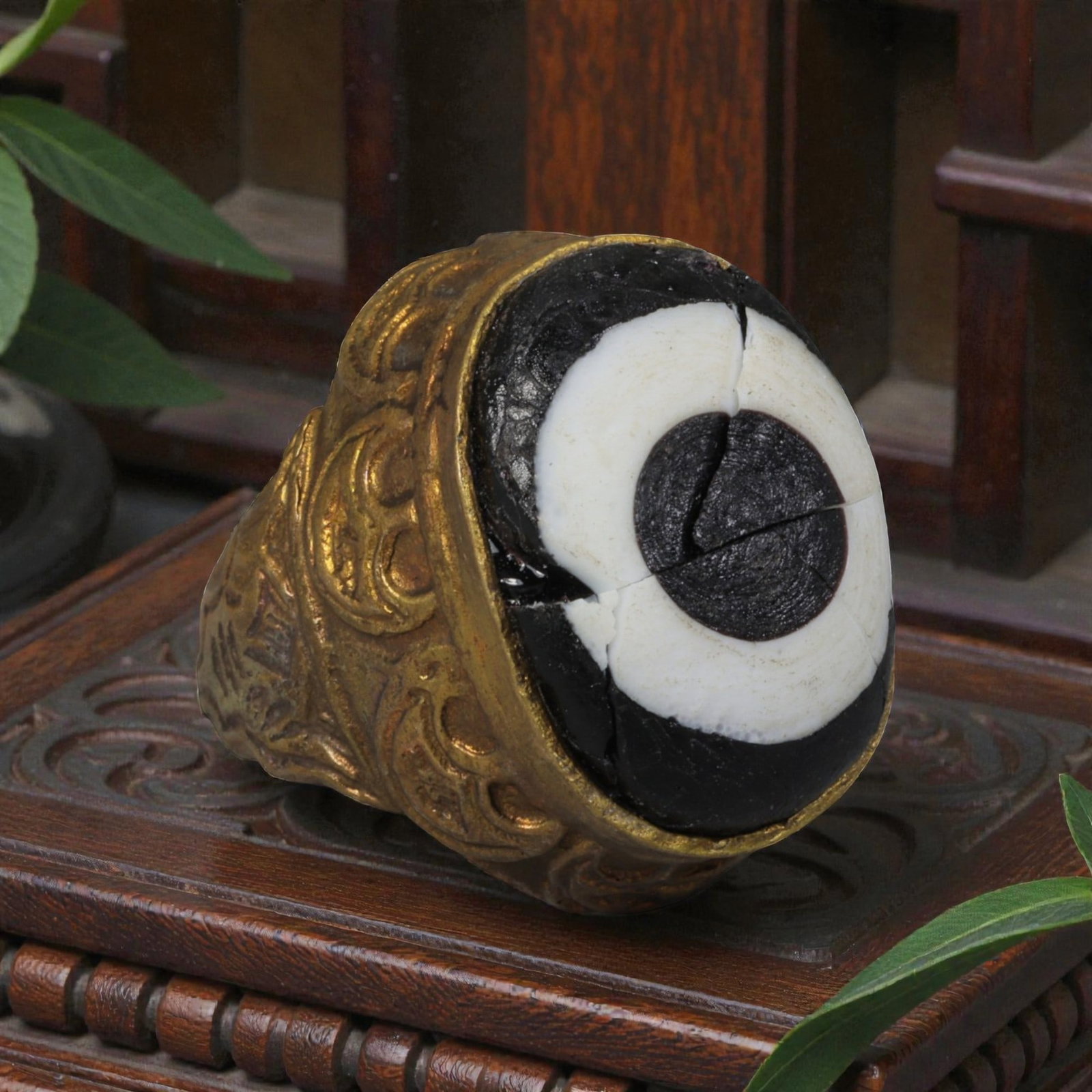 Antique Qajar Dynasty Gilt Evil Eye Ring, US Size 7, 31AJ: A gilt-metal ring of the Qajar period, US ring size 7, featuring a large domed evil-eye glass inlay with a bold concentric black-and-white design (the glass exhibits age-related cracks). The bezel and