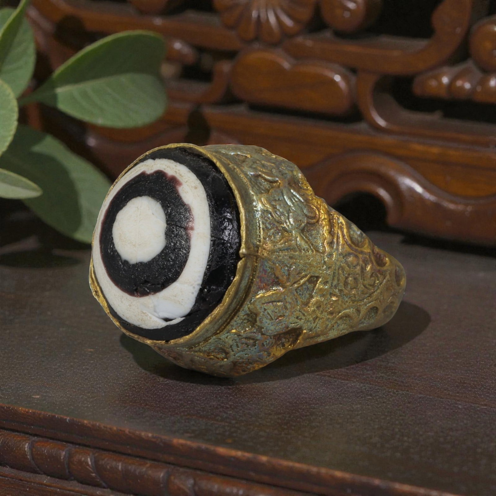 Antique Qajar Dynasty Gilt Evil Eye Ring, US Size 8.5, 20AJ: A gilt-metal ring of the Qajar period, US ring size 8.5, featuring a large domed evil-eye glass inlay with a bold concentric black-and-white design (the glass exhibits age-related cracks). The bezel a