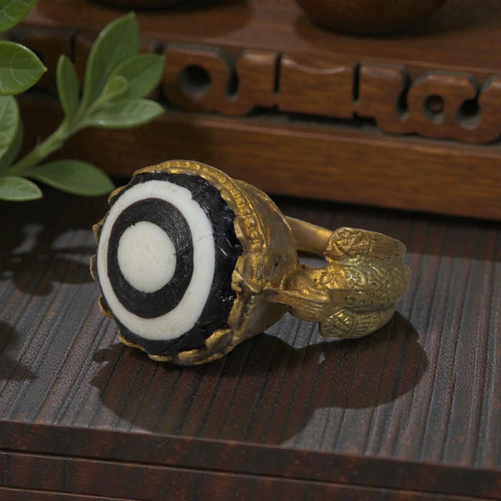 Antique Qajar Dynasty Gilt Evil Eye Ring, US Size 8.5, 22AJ: A gilt-metal ring of the Qajar period, US ring size 8.5, featuring a large domed evil-eye glass inlay with a bold concentric black-and-white design (the glass exhibits age-related cracks). The bezel i