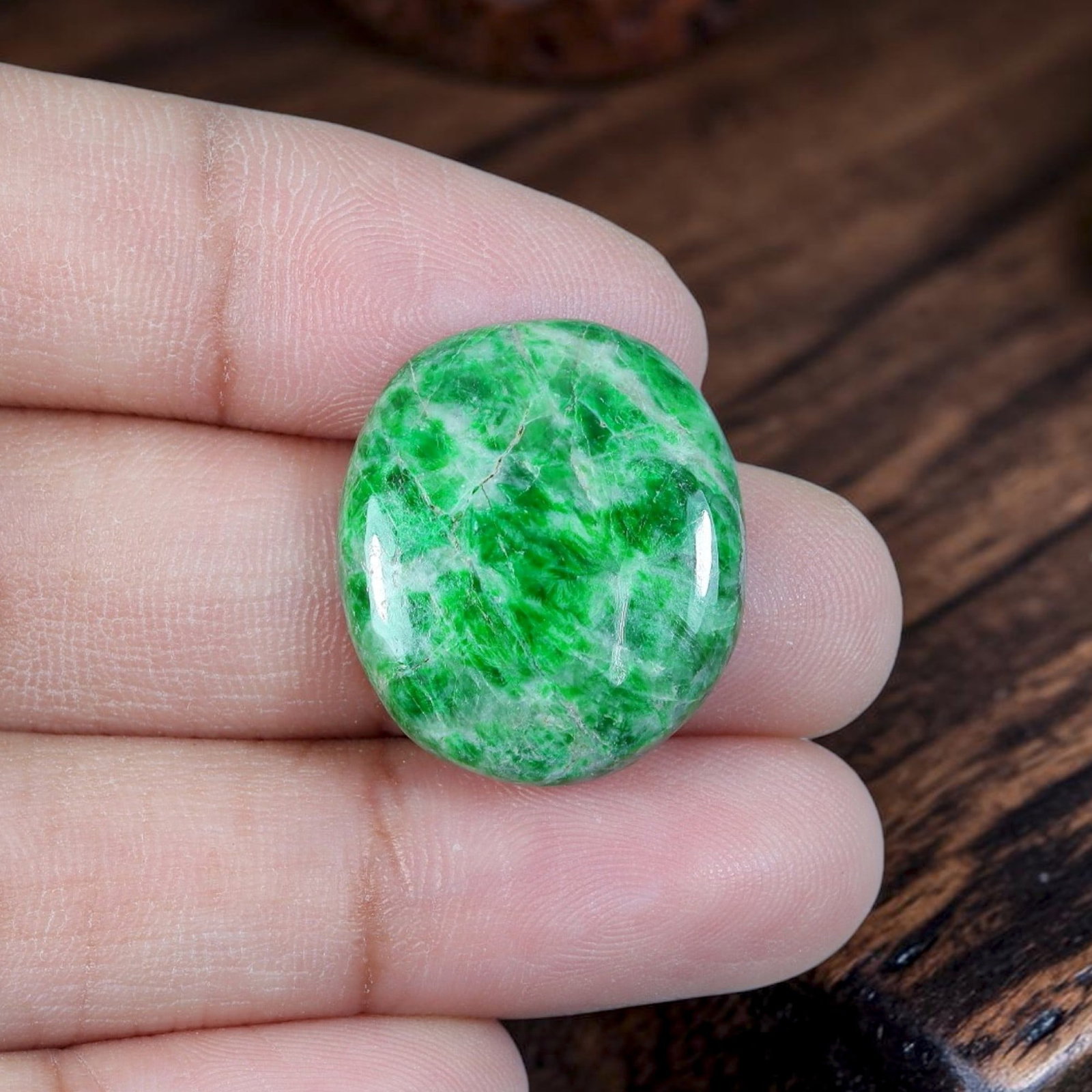 15.07ct Natural Burmese Type A Jadeite Jade Cabochon, 95EB: Polished from untreated natural Burmese Type A jadeite jade, this rounded oval cabochon features glossy domed top and thin flat base suited for ring mounting. Bright vivid emerald green swirls organic