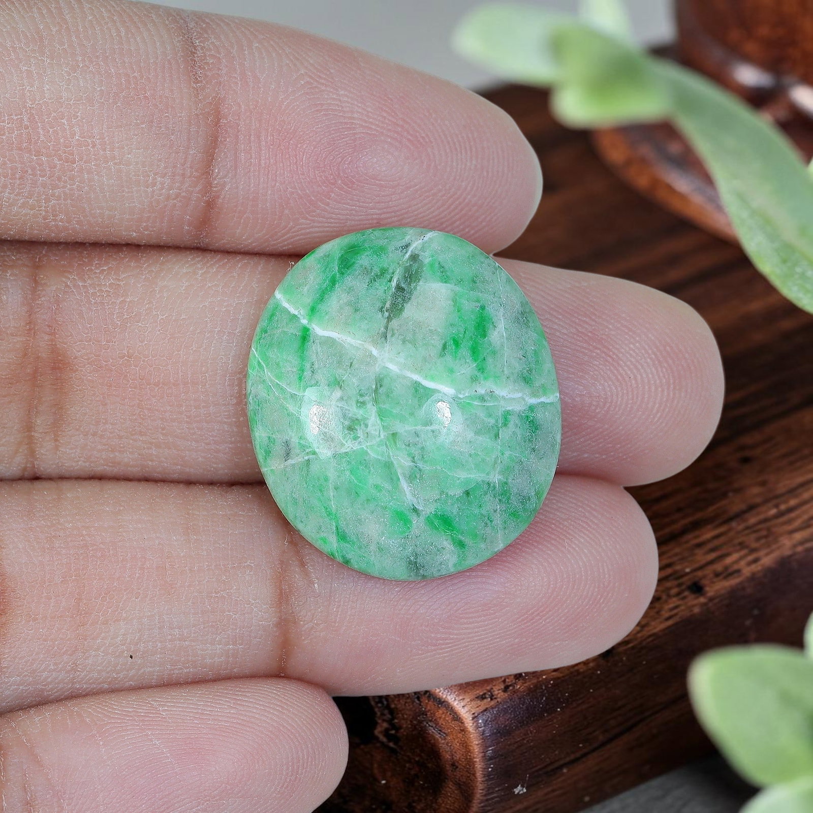 17.17ct Natural Burmese Type A Jadeite Jade Oval Cabochon, 83AP: Polished from untreated natural Burmese Type A jadeite jade, this oval cabochon features plump domed polish and flat base suitable for ring or small pendant setting. Pale milky green base matrix carri