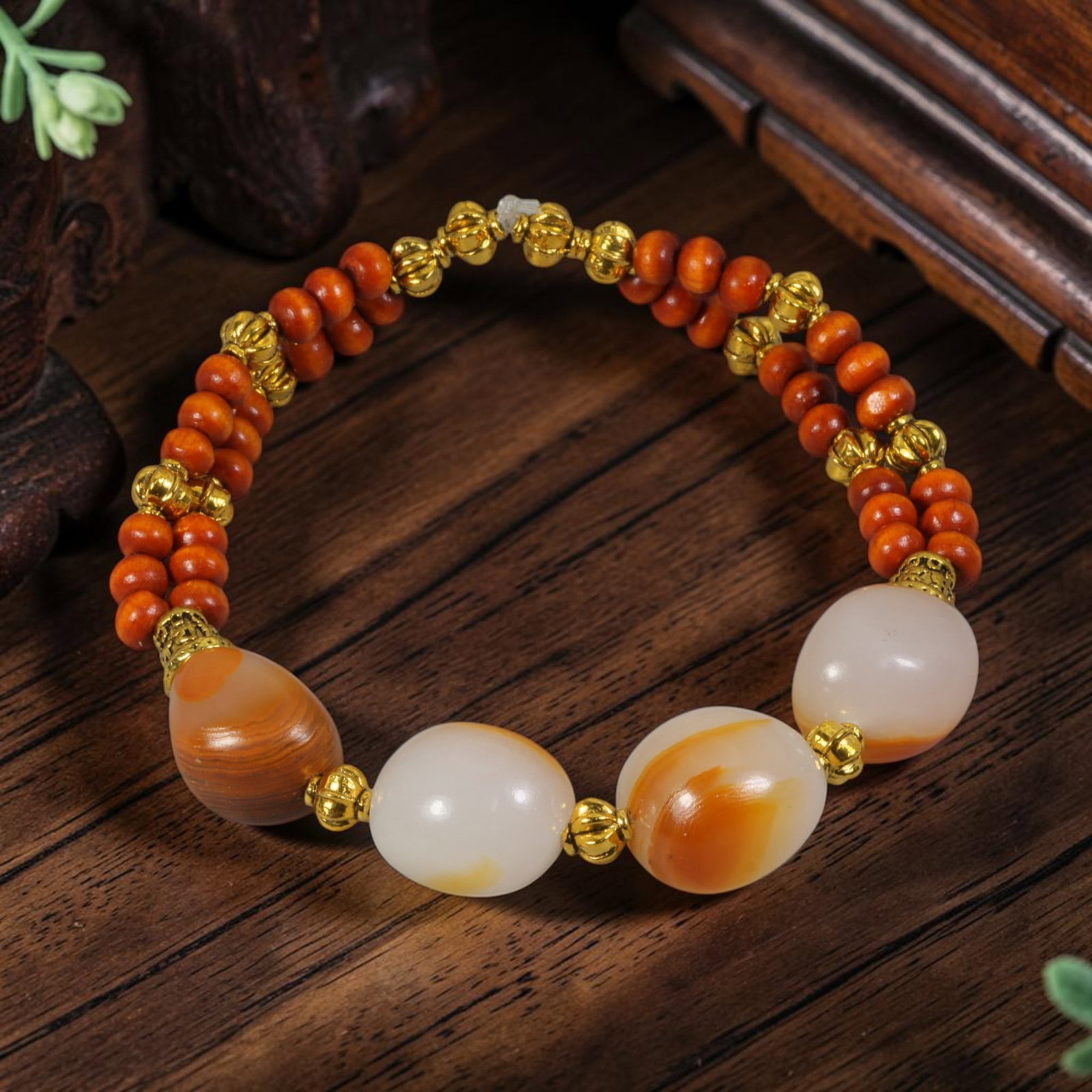 Chinese Hetian Nephrite White Seed Pebble Jade Bracelet with Gold-Tone Wood Bead, 81AR: This artisanal bracelet centers on three natural Hetian nephrite seed pebble jade beads with smooth organic oval shapes, milky white base stone naturally marked with soft warm russet orange river skin