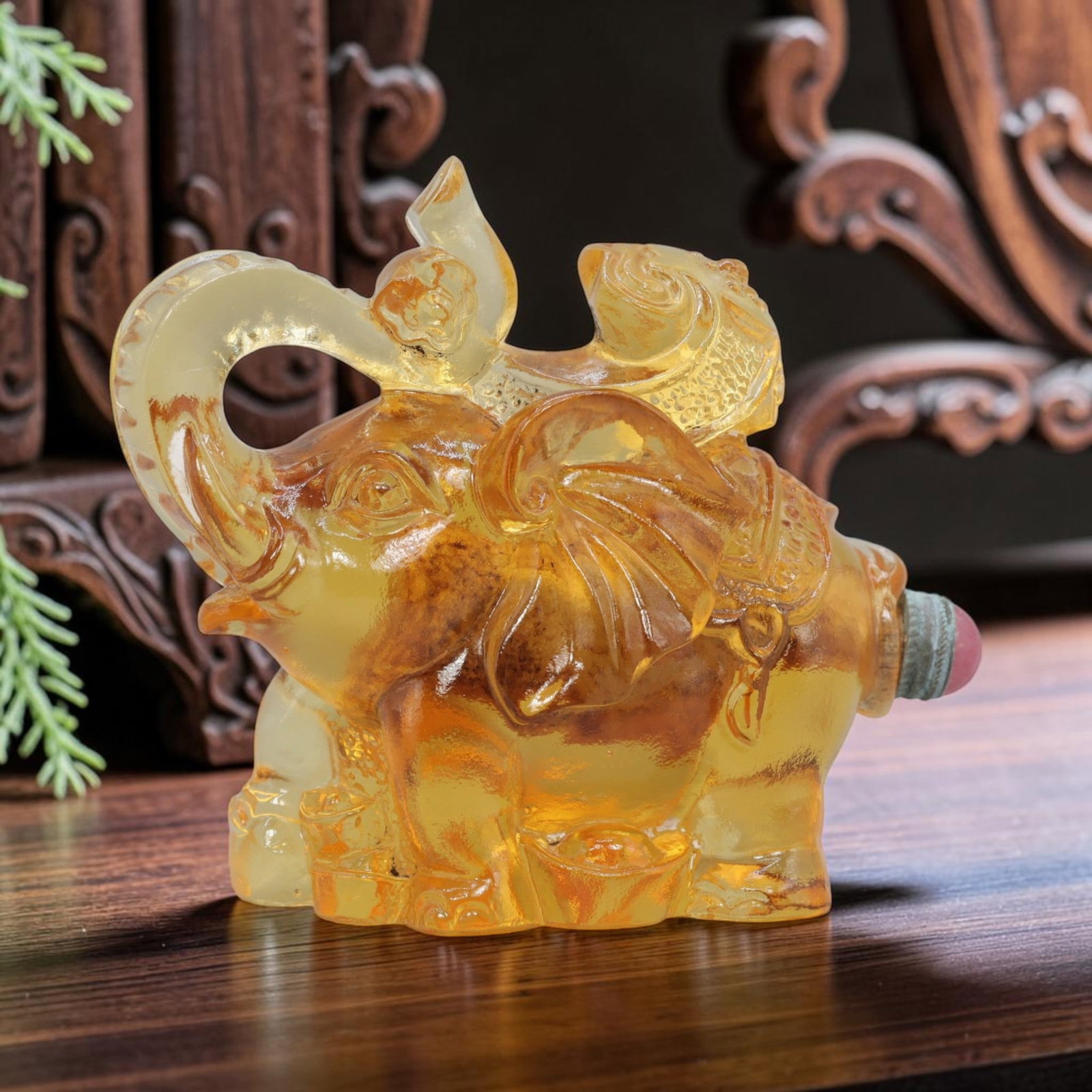 Vintage Chinese Liuli Glass Snuff Bottle - Elephant Figurine, 63YF: Crafted from translucent amber-toned liuli glass, this snuff bottle is sculpted in the form of a standing elephant, its trunk raised and curled upward. The elephant's back is adorned with a child figu